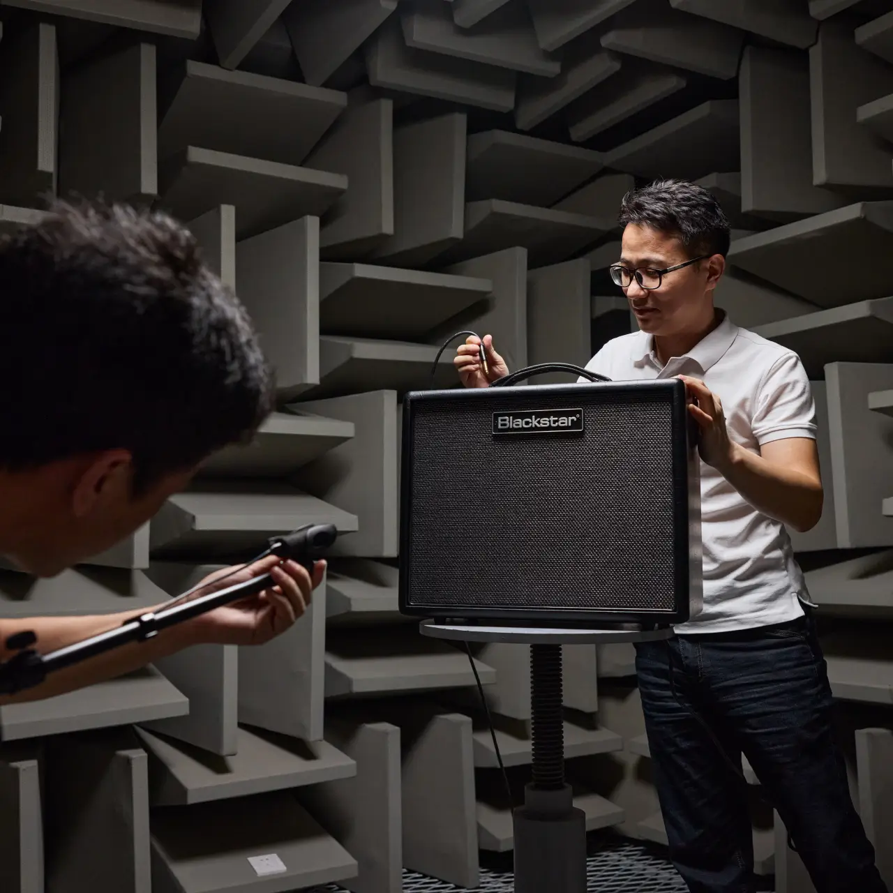 Two Ryder Industries engineers checking compliance on a Blackstar guitar amplifier.