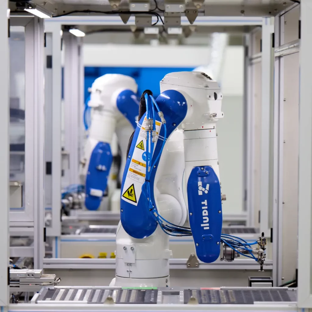 A close-up of a robotic arm in testing line.