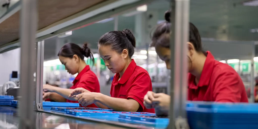 Three Ryder Industries assembly line workers carrying out checks.