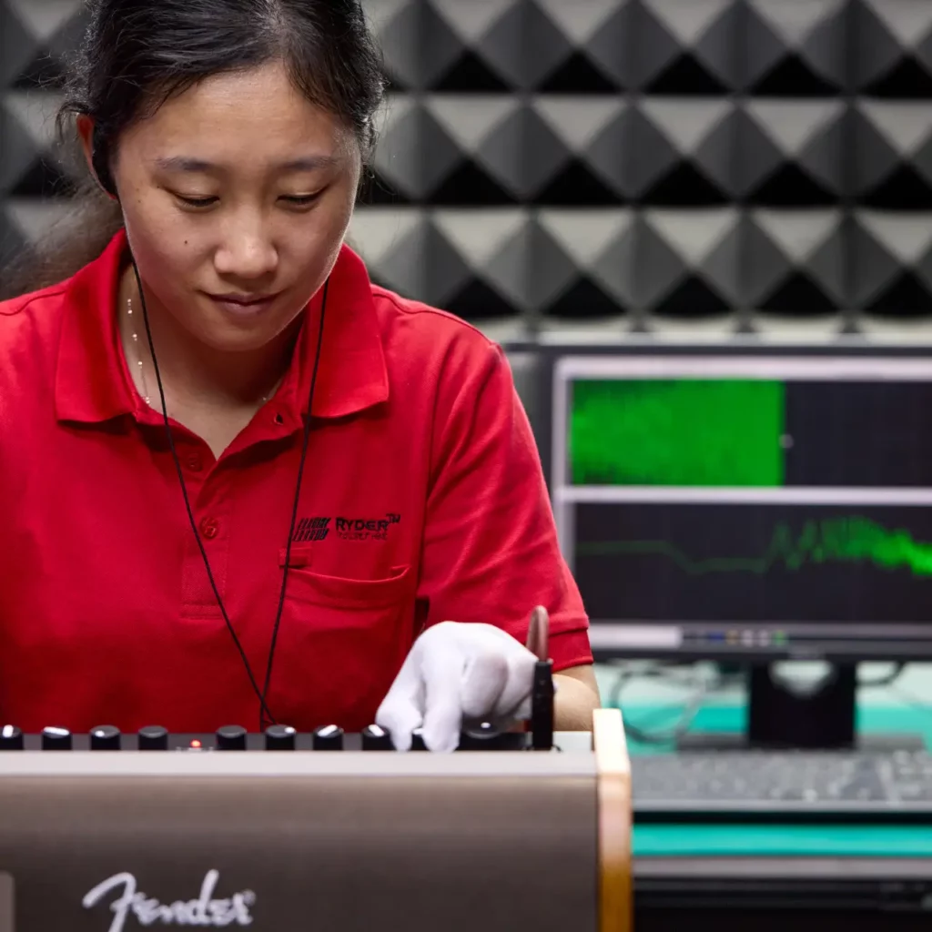 A Ryder Industries worker testing a Fender audio product.