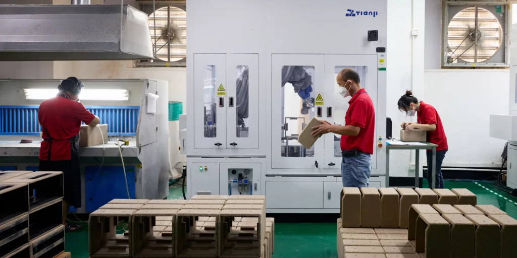 Three Ryder Industries employees handling packaged products.
